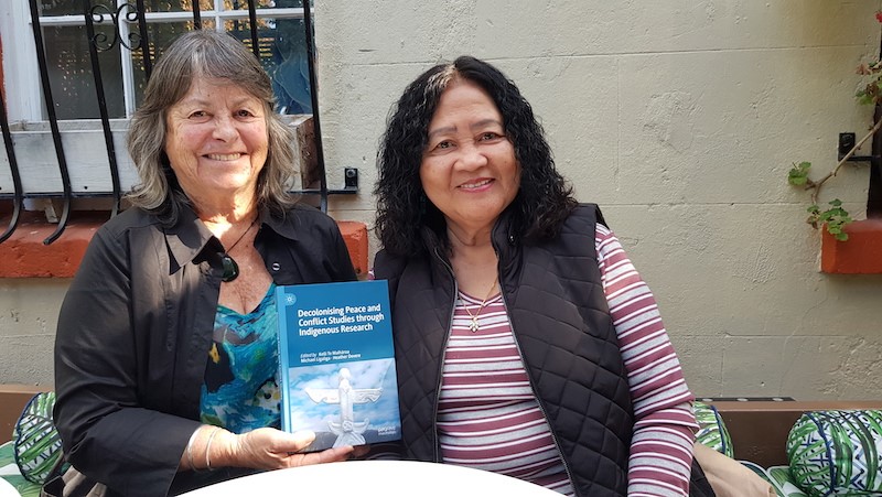 Heather Devere and PJR designer Del Abcede catch up at Ponsonby's Little Garden café and discuss Heather's latest book on peace and conflict studies and Indigenous research.